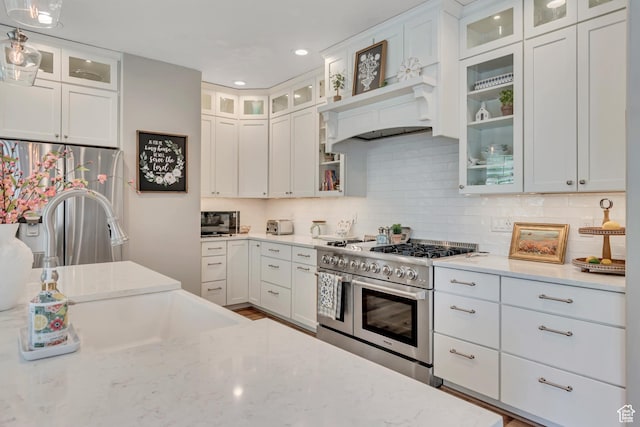 3065 W Current Creek Dr, South Jordan, UT 84095 - kitchen with stainless steel appliances, light stone countertops, backsplash, and recessed lighting