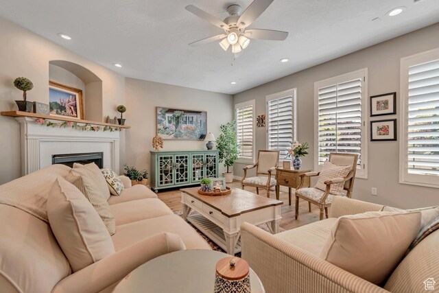 3065 W Current Creek Dr, South Jordan, UT 84095 - living room featuring wood finished floors, a ceiling fan, a fireplace, and recessed lighting