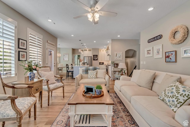 3065 W Current Creek Dr, South Jordan, UT 84095 - living area featuring light wood-type flooring, ceiling fan, arched walkways, and recessed lighting