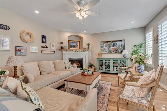 3065 W Current Creek Dr, South Jordan, UT 84095 - living area featuring a ceiling fan, wood finished floors, a glass covered fireplace, and recessed lighting