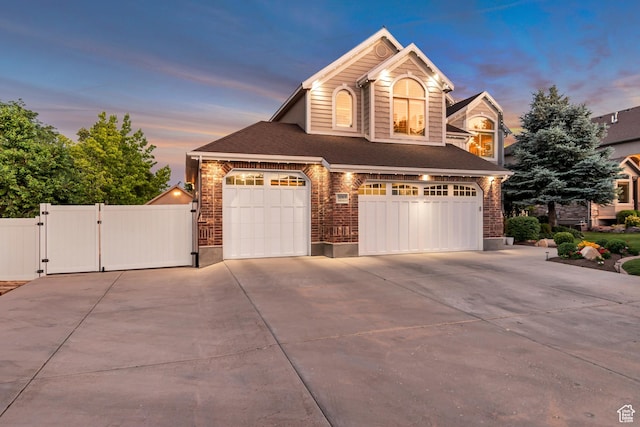 3065 W Current Creek Dr, South Jordan, UT 84095 - view of front of home with a gate, driveway, a garage, brick siding, and a shingled roof