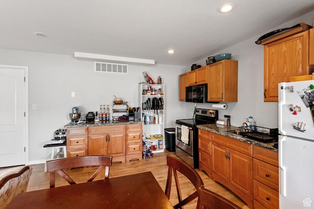 1226 N 3020 W, Provo, UT 84601 - kitchen with stainless steel electric range, freestanding refrigerator, black microwave, light wood-style floors, and dark stone counters