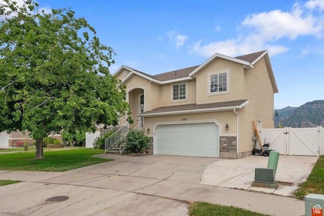 1226 N 3020 W, Provo, UT 84601 - view of front of house featuring a gate, stucco siding, a garage, concrete driveway, and stone siding