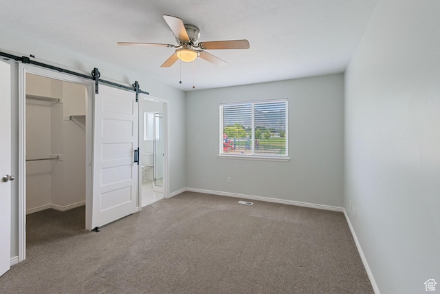 1226 N 3020 W, Provo, UT 84601 - unfurnished bedroom featuring a barn door, a spacious closet, carpet flooring, and connected bathroom