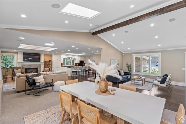 8022 S Deer Creek Rd E, Cottonwood Heights, UT 84121 - dining room featuring crown molding, a large fireplace, a skylight, and recessed lighting