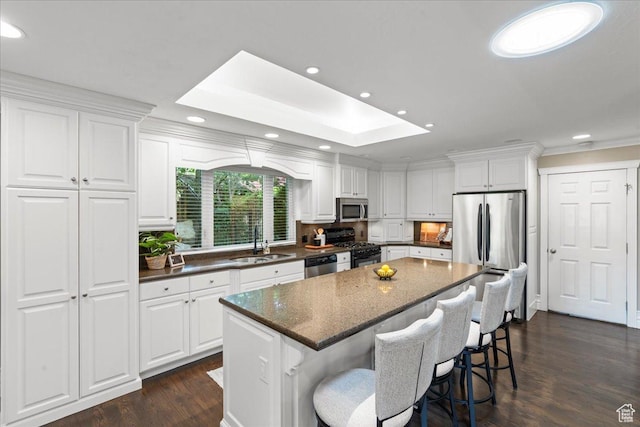8022 S Deer Creek Rd E, Cottonwood Heights, UT 84121 - kitchen featuring appliances with stainless steel finishes, white cabinets, dark wood finished floors, a kitchen island, and recessed lighting