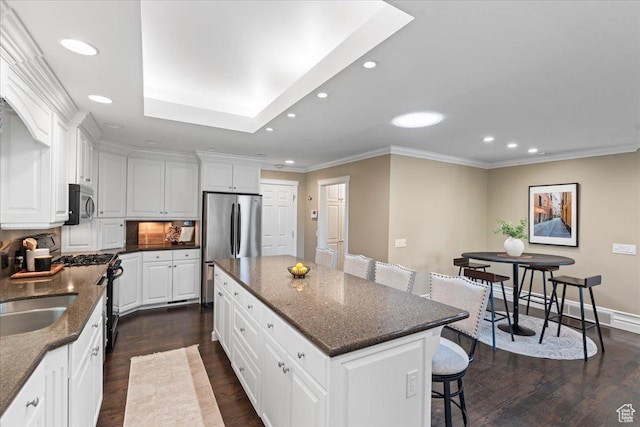 8022 S Deer Creek Rd E, Cottonwood Heights, UT 84121 - kitchen with appliances with stainless steel finishes, a breakfast bar, recessed lighting, a center island, and dark wood-style floors
