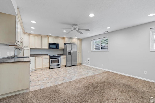 8022 S Deer Creek Rd E, Cottonwood Heights, UT 84121 - kitchen with appliances with stainless steel finishes, dark countertops, light carpet, a ceiling fan, and recessed lighting