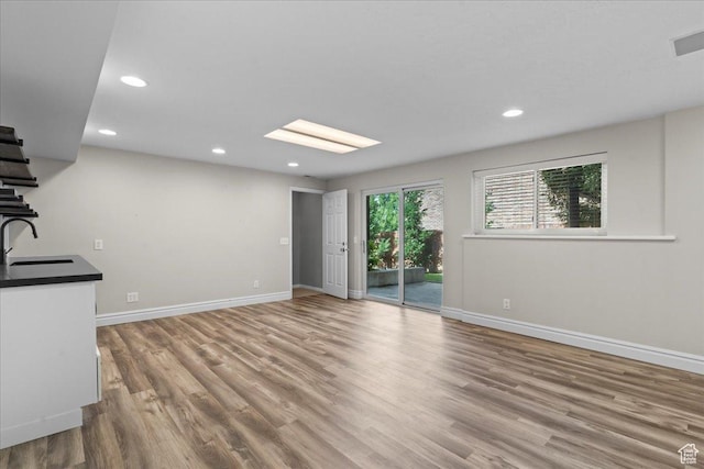 8022 S Deer Creek Rd E, Cottonwood Heights, UT 84121 - unfurnished living room featuring wood finished floors, recessed lighting, and stairway