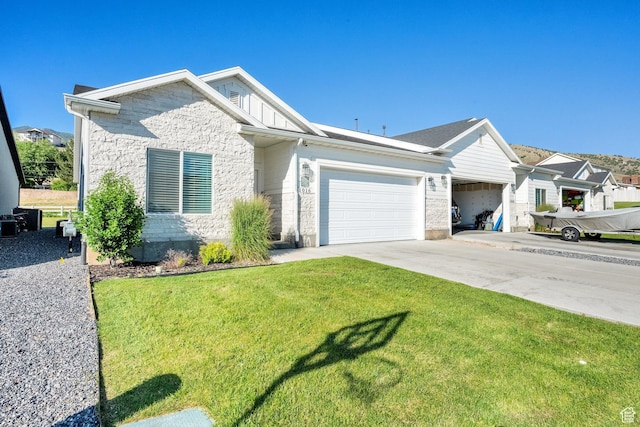 1016 N Vista Loop, Morgan, UT 84050 - view of front of property with a garage, a front yard, concrete driveway, and stone siding