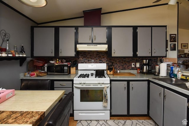 93 N Sherman St, Stockton, UT 84071 - kitchen with white gas range oven, under cabinet range hood, stainless steel microwave, ornamental molding, and light countertops