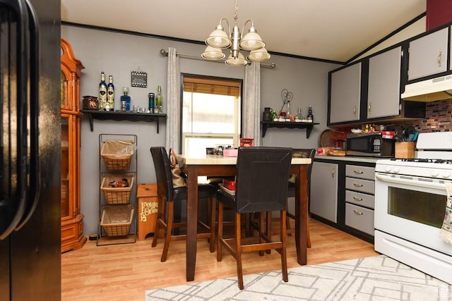 93 N Sherman St, Stockton, UT 84071 - kitchen with white range oven, under cabinet range hood, black fridge, stainless steel microwave, and a chandelier