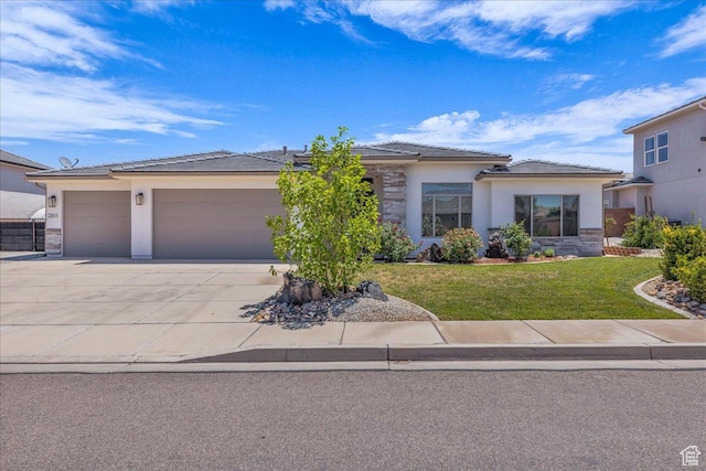 2811 S 3210 E, St George, UT 84790 - view of front facade with an attached garage, driveway, stucco siding, and a front yard
