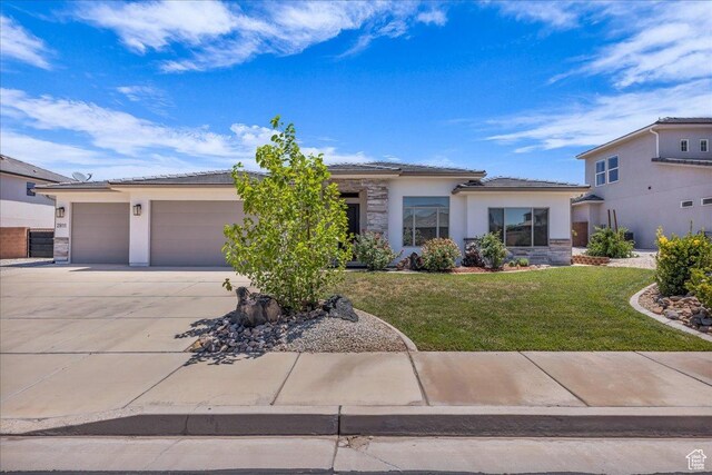 2811 S 3210 E, St George, UT 84790 - view of front facade featuring stucco siding, concrete driveway, a garage, and a front lawn