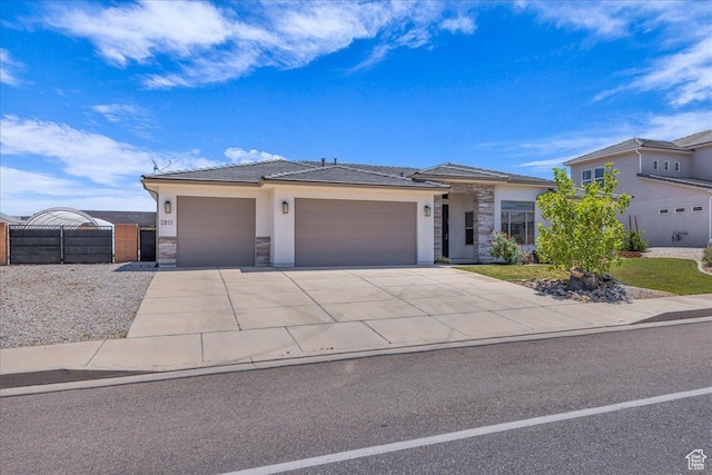 2811 S 3210 E, St George, UT 84790 - view of front of property with stone siding, an attached garage, concrete driveway, stucco siding, and a gate