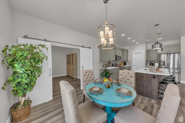 2811 S 3210 E, St George, UT 84790 - dining area featuring a barn door, light wood-type flooring, a chandelier, and recessed lighting