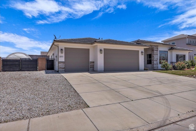 2811 S 3210 E, St George, UT 84790 - prairie-style home with an attached garage, stucco siding, a gate, and driveway