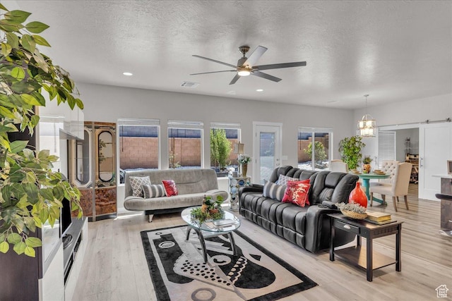 2811 S 3210 E, St George, UT 84790 - living area featuring ceiling fan, light wood-type flooring, a barn door, recessed lighting, and a textured ceiling