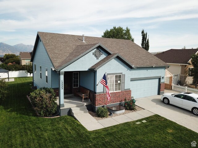 13333 S Alonzo Ln W, Herriman, UT 84096 - ranch-style house with roof with shingles, driveway, a garage, brick siding, and stucco siding