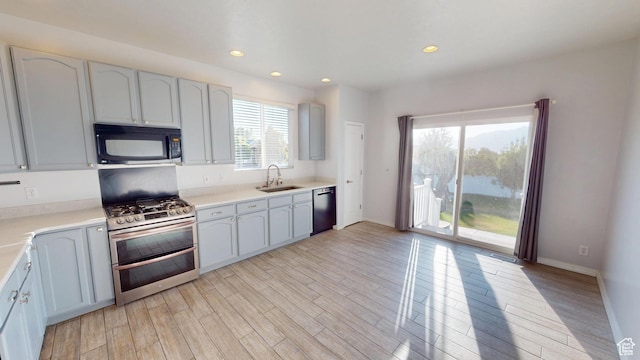 13333 S Alonzo Ln W, Herriman, UT 84096 - kitchen featuring black microwave, double oven range, dishwasher, light wood-type flooring, and recessed lighting