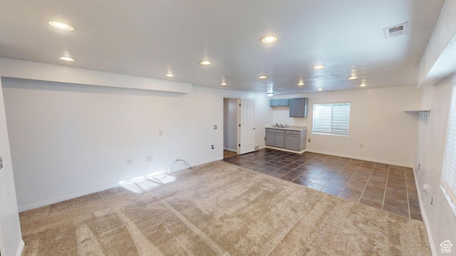 13333 S Alonzo Ln W, Herriman, UT 84096 - unfurnished living room featuring recessed lighting, dark tile patterned floors, and dark colored carpet