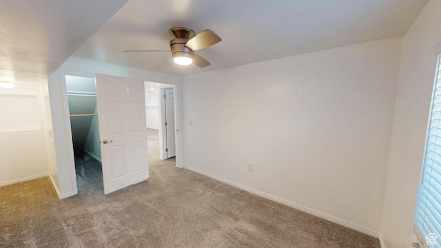 13333 S Alonzo Ln W, Herriman, UT 84096 - unfurnished bedroom featuring carpet flooring, a walk in closet, and a ceiling fan