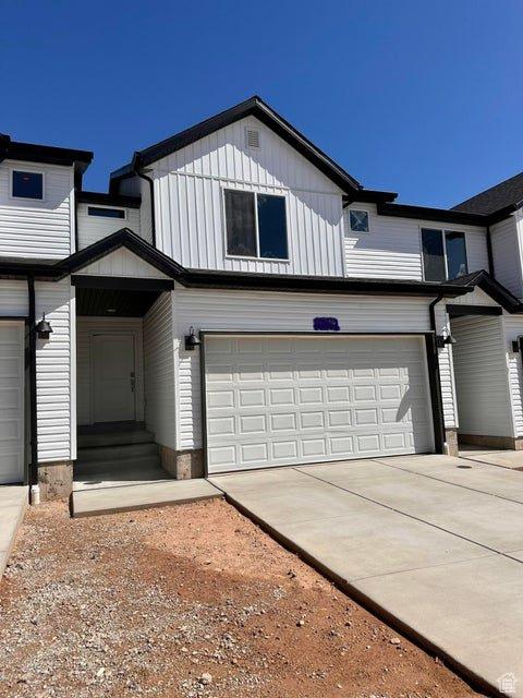 2944 W Ezra Dr, Cedar City, UT 84720 - view of front of house featuring concrete driveway, a garage, and board and batten siding