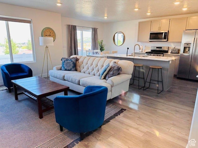 2944 W Ezra Dr, Cedar City, UT 84720 - living room featuring light wood-style floors and recessed lighting