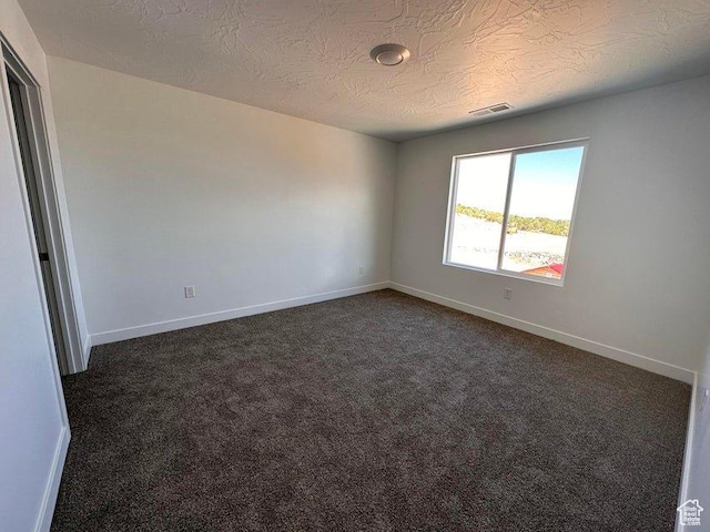 2944 W Ezra Dr, Cedar City, UT 84720 - empty room with dark colored carpet and a textured ceiling