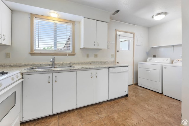 88 W 50 S Unit J8, Centerville, UT 84014 - laundry room featuring washing machine and clothes dryer, plenty of natural light, and light tile patterned floors
