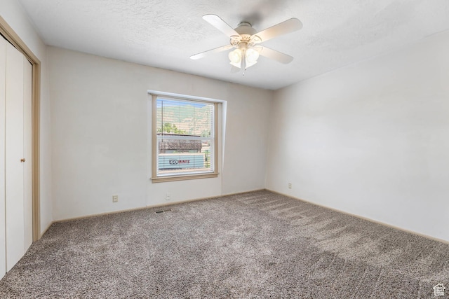88 W 50 S Unit J8, Centerville, UT 84014 - unfurnished bedroom featuring carpet flooring, a closet, a ceiling fan, and a textured ceiling