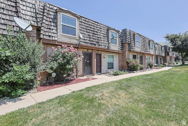88 W 50 S Unit J8, Centerville, UT 84014 - view of front of home with mansard roof, a front lawn, and brick siding