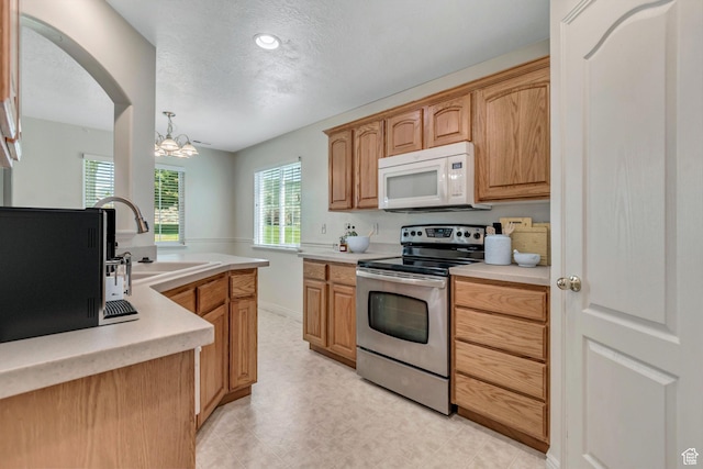 1489 S Silver Maple Ct, Payson, UT 84651 - kitchen with stainless steel electric stove, white microwave, a chandelier, light countertops, and a textured ceiling