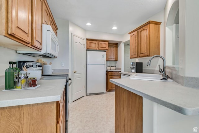 1489 S Silver Maple Ct, Payson, UT 84651 - kitchen with white appliances, recessed lighting, light countertops, brown cabinetry, and light flooring