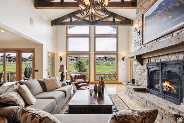 2711 E Bitter Brush Dr, Park City, UT 84098 - living area featuring high vaulted ceiling, a stone fireplace, beam ceiling, and wood finished floors