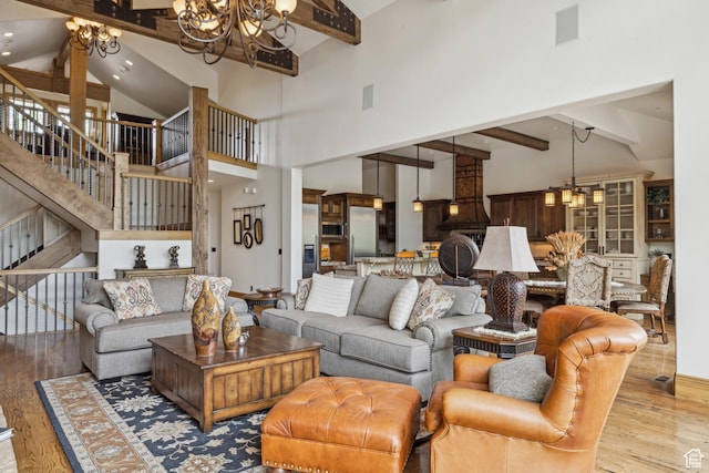 2711 E Bitter Brush Dr, Park City, UT 84098 - living room with a chandelier, beamed ceiling, wood finished floors, stairs, and high vaulted ceiling