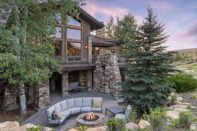 2711 E Bitter Brush Dr, Park City, UT 84098 - patio terrace at dusk with an outdoor living space with a fire pit, a patio area, and a deck