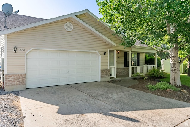 888 S Mallard Loop W, Logan, UT 84321 - single story home featuring brick siding, a porch, concrete driveway, an attached garage, and roof with shingles
