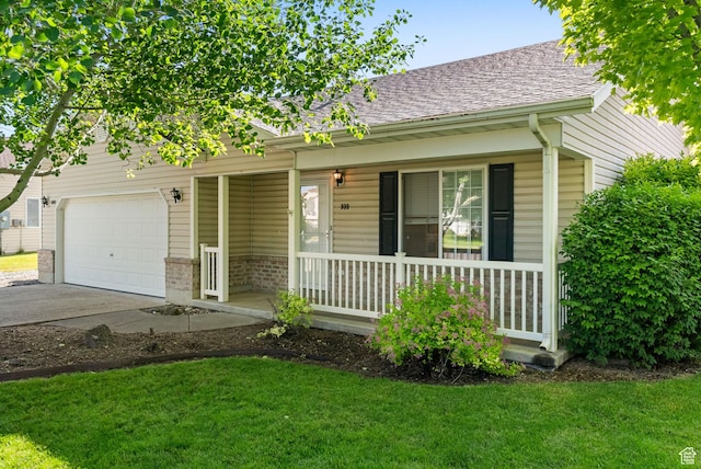 888 S Mallard Loop W, Logan, UT 84321 - view of front of home with a porch, an attached garage, driveway, a front yard, and brick siding