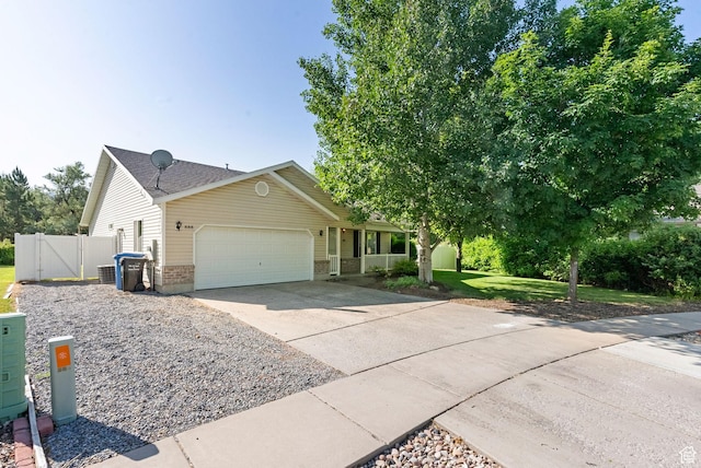 888 S Mallard Loop W, Logan, UT 84321 - view of front of property featuring an attached garage, driveway, a porch, a gate, and brick siding