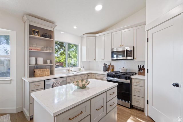1153 N 280 W, American Fork, UT 84003 - kitchen with stainless steel appliances, light wood-style flooring, backsplash, light stone counters, and a kitchen island