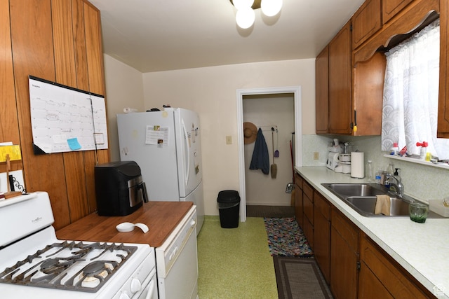 2758 Fowler Ave, Ogden, UT 84403 - kitchen with white appliances, brown cabinets, light countertops, tasteful backsplash, and light flooring