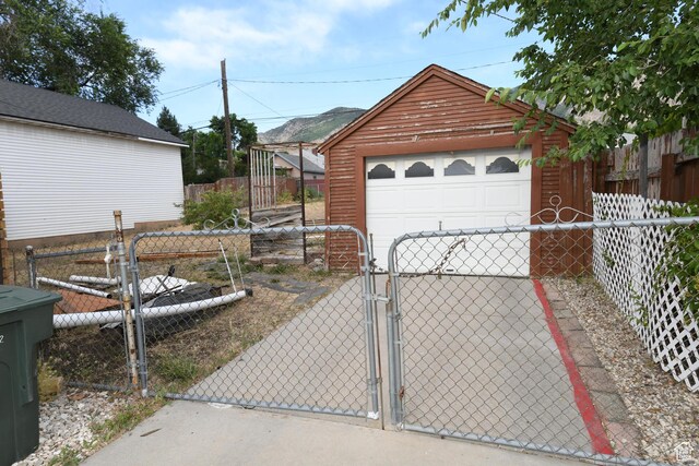 2758 Fowler Ave, Ogden, UT 84403 - detached garage with a gate, driveway, and a garden