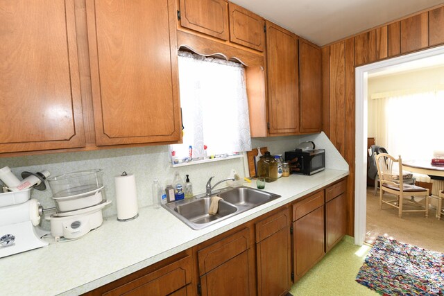 2758 Fowler Ave, Ogden, UT 84403 - kitchen with black microwave, light countertops, and brown cabinets
