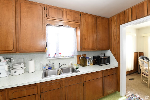2758 Fowler Ave, Ogden, UT 84403 - kitchen featuring light countertops, stainless steel microwave, and brown cabinetry