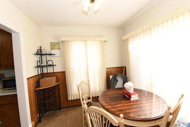 2758 Fowler Ave, Ogden, UT 84403 - dining area featuring healthy amount of natural light, wainscoting, carpet floors, and wood walls