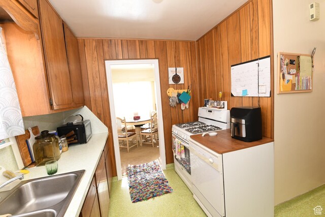2758 Fowler Ave, Ogden, UT 84403 - kitchen with white appliances, brown cabinets, light countertops, and light carpet