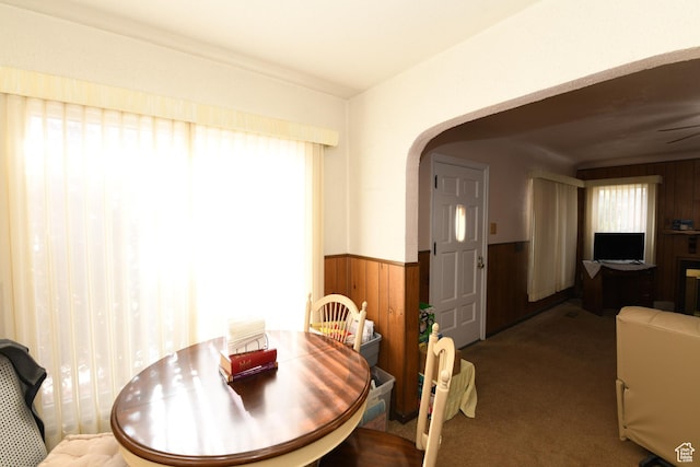 2758 Fowler Ave, Ogden, UT 84403 - dining room with arched walkways, wainscoting, wood walls, and carpet