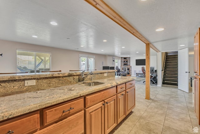 11645 S Keystone Dr, South Jordan, UT 84009 - kitchen with recessed lighting, light stone countertops, light tile patterned floors, open floor plan, and brown cabinetry