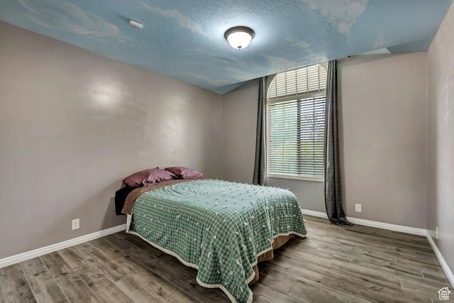 11645 S Keystone Dr, South Jordan, UT 84009 - bedroom featuring wood finished floors and a textured ceiling